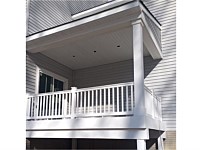 <b>A Backyard porch with white vinyl railing and posts</b>